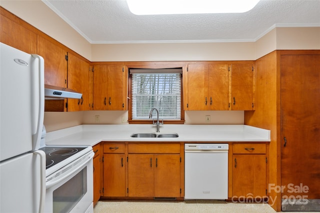 kitchen featuring a textured ceiling, crown molding, white appliances, and sink