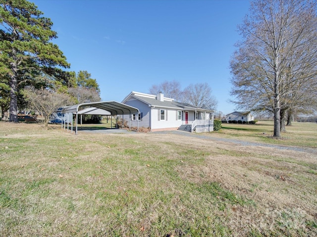 view of front of home with a front lawn and a carport