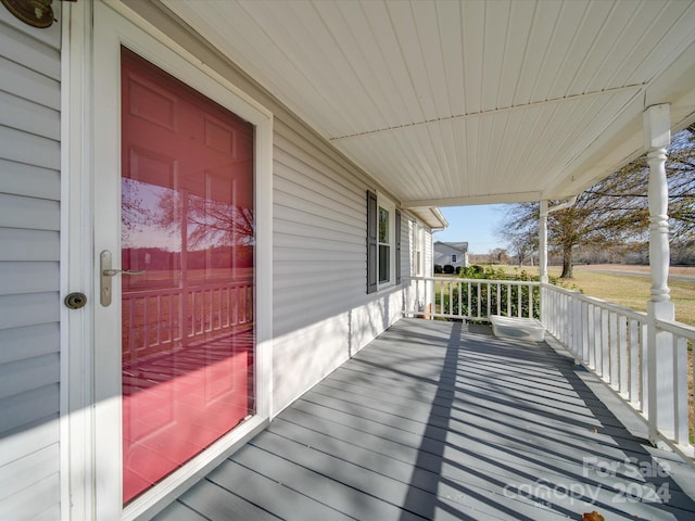 wooden terrace featuring covered porch