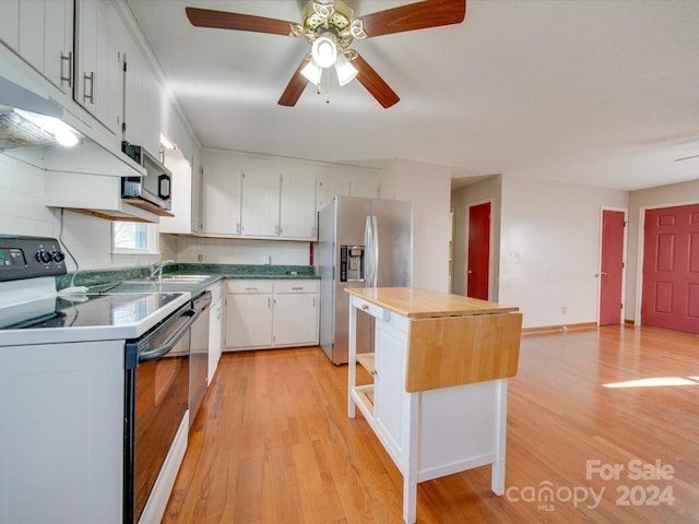 kitchen with white cabinetry, sink, stainless steel appliances, tasteful backsplash, and light hardwood / wood-style floors