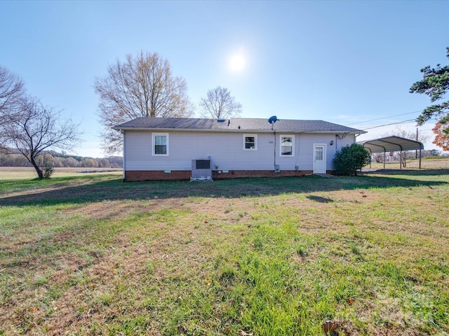 back of property featuring a carport and a lawn