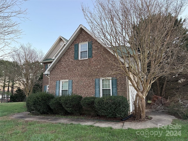 view of home's exterior with a lawn