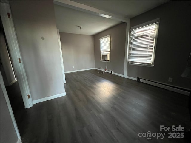 unfurnished room featuring cooling unit, baseboard heating, and dark wood-type flooring