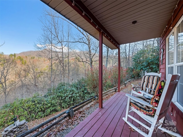 wooden terrace featuring covered porch