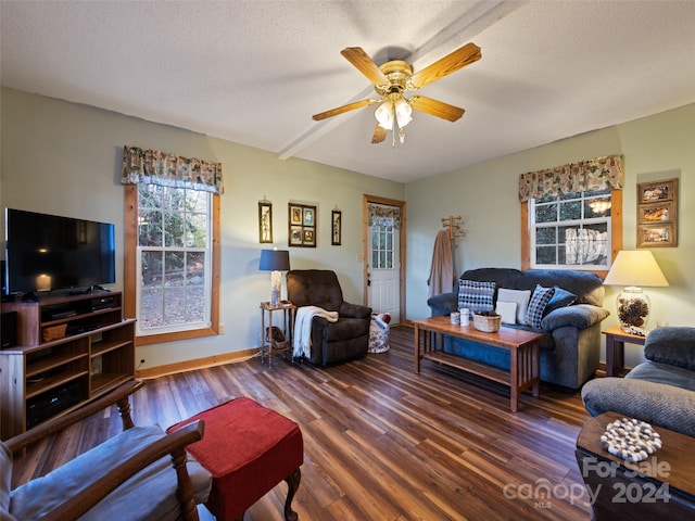 living room with a textured ceiling, dark hardwood / wood-style floors, and ceiling fan