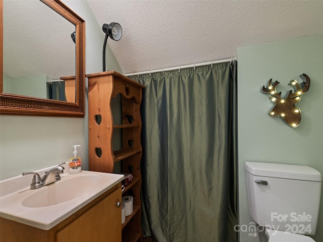 bathroom with vanity, a textured ceiling, toilet, and vaulted ceiling