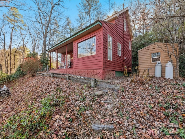 view of side of property featuring covered porch