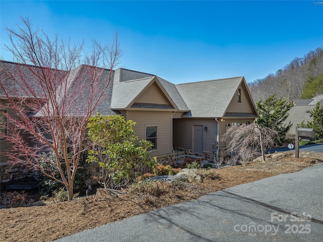 20 Red Plum Ln, Black Mountain, NC 28711 - view of front facade featuring a garage, stone siding, and roof with shingles