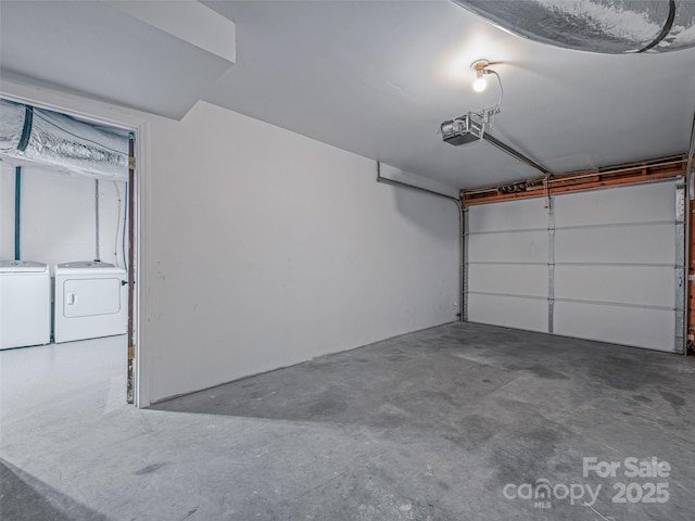 garage with a garage door opener and washer and clothes dryer