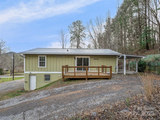 back of house with a deck