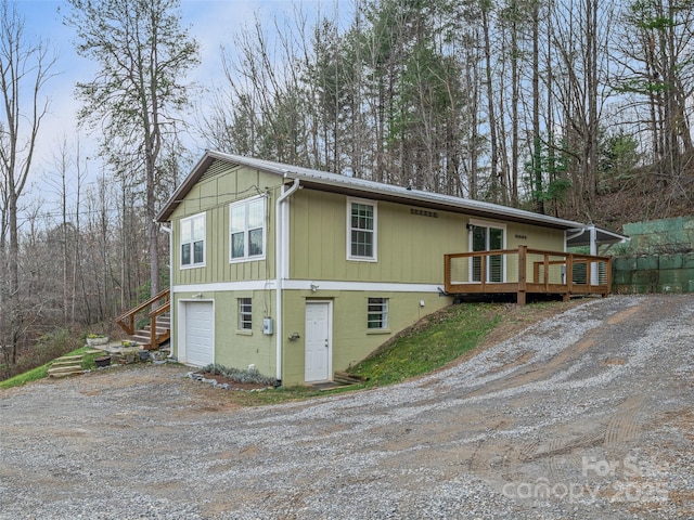 exterior space with a wooden deck and a garage