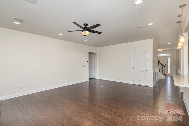 empty room with ceiling fan and dark wood-type flooring