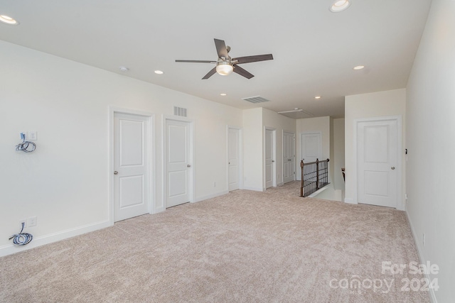 carpeted spare room with ceiling fan