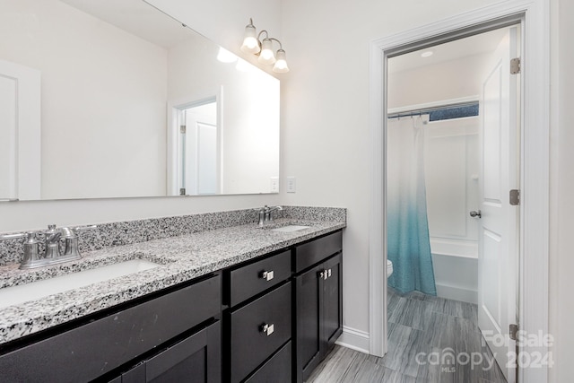 full bathroom with vanity, shower / bath combo, and toilet