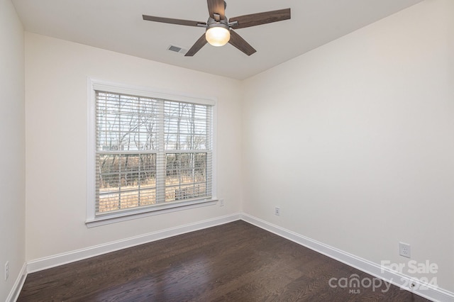 spare room with dark hardwood / wood-style floors and ceiling fan