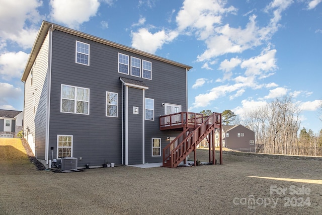 back of property with cooling unit and a wooden deck