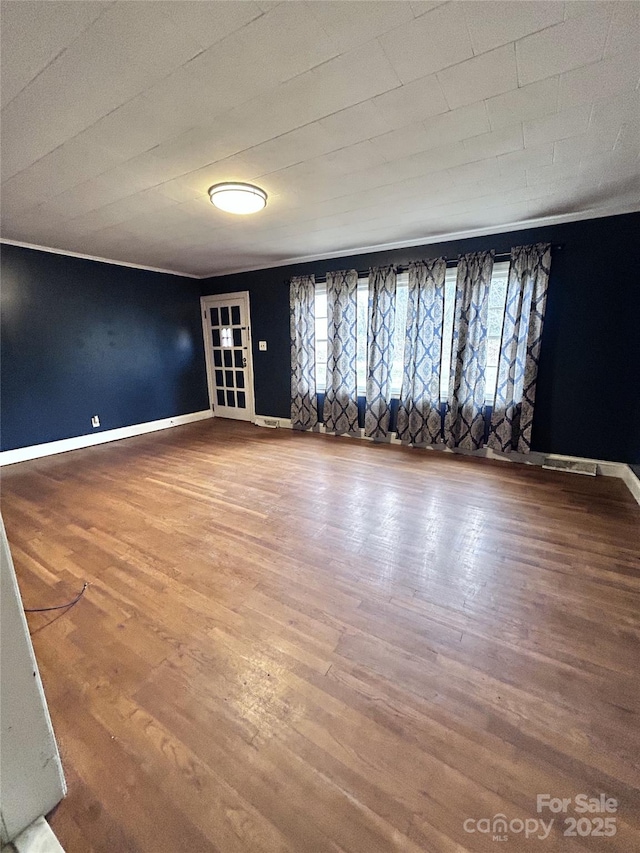 empty room with hardwood / wood-style flooring