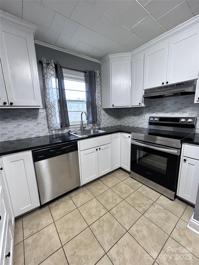 kitchen with crown molding, sink, decorative backsplash, appliances with stainless steel finishes, and white cabinetry