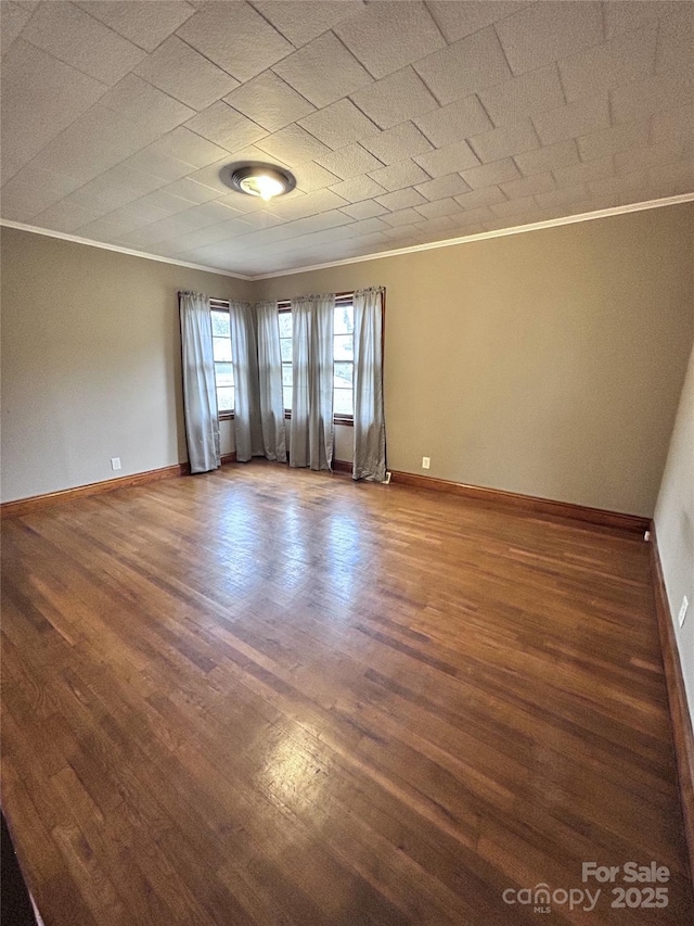 spare room with hardwood / wood-style floors and ornamental molding