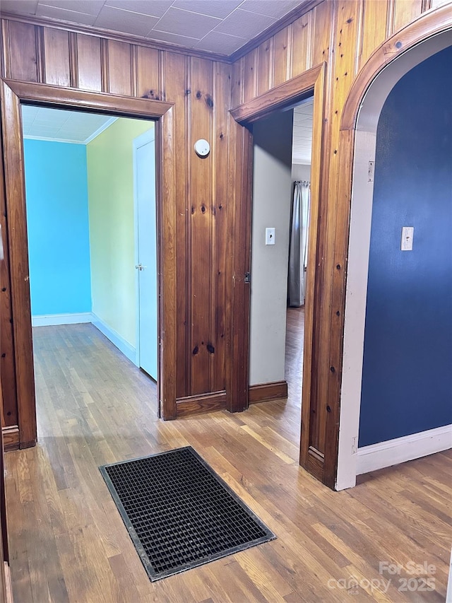 corridor featuring light hardwood / wood-style floors and ornamental molding