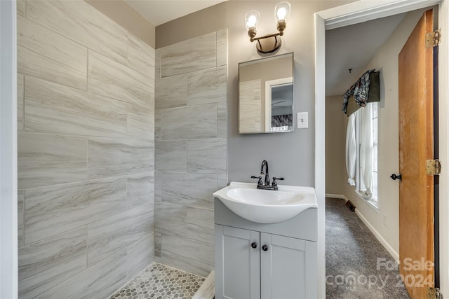 bathroom featuring vanity and tiled shower