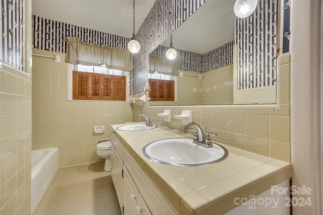 bathroom with tasteful backsplash, tile patterned flooring, tile walls, and toilet