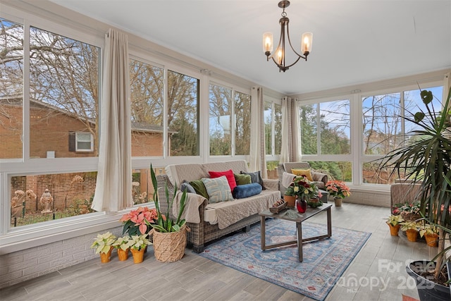 sunroom featuring a notable chandelier