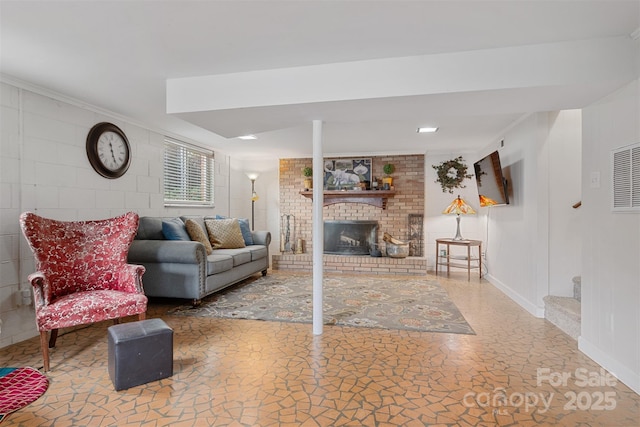 living room featuring crown molding and a brick fireplace