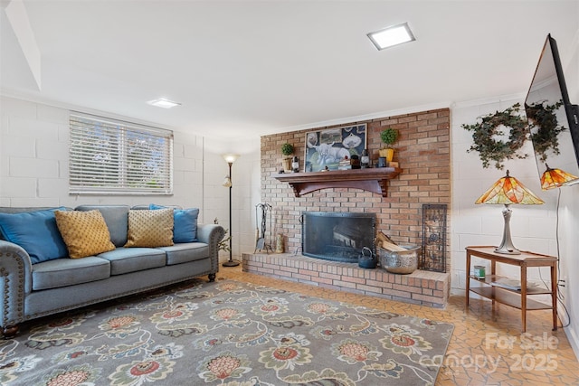 living room with ornamental molding and a fireplace