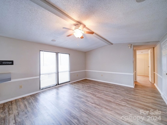 unfurnished room with vaulted ceiling with beams, a textured ceiling, light hardwood / wood-style floors, and ceiling fan