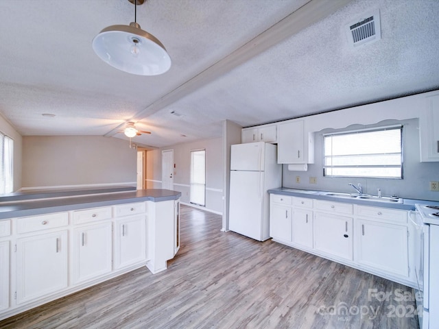 kitchen with lofted ceiling, white cabinetry, light hardwood / wood-style floors, and white appliances