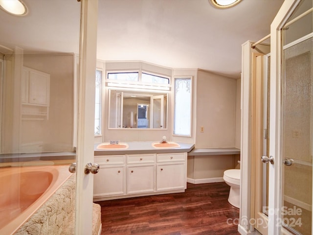 full bathroom with wood-type flooring, vanity, toilet, and independent shower and bath