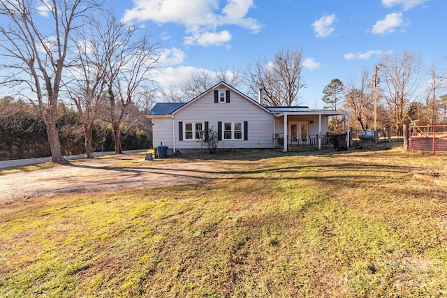 back of property with a porch and a lawn