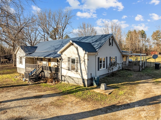 view of side of home with a porch