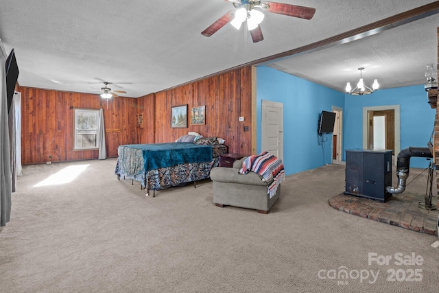 bedroom featuring ceiling fan with notable chandelier, a textured ceiling, wooden walls, and carpet flooring