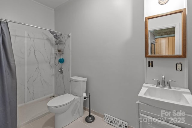 bathroom featuring curtained shower, tile patterned flooring, vanity, and toilet