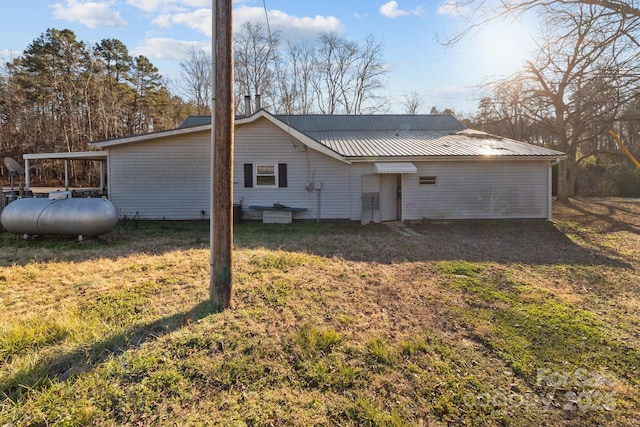 rear view of property featuring a lawn