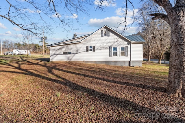 view of side of home with a lawn