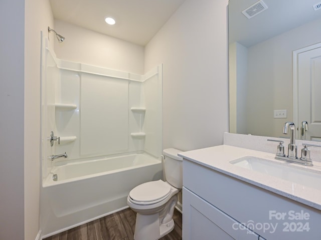 full bathroom featuring shower / washtub combination, vanity, wood-type flooring, and toilet