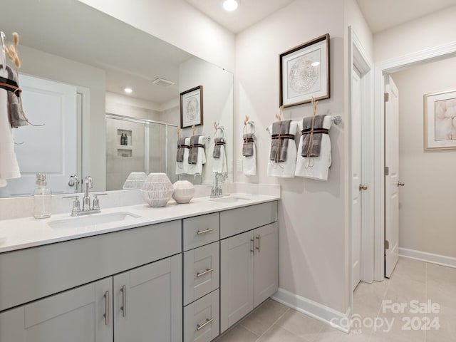 bathroom with tile patterned floors, vanity, and an enclosed shower