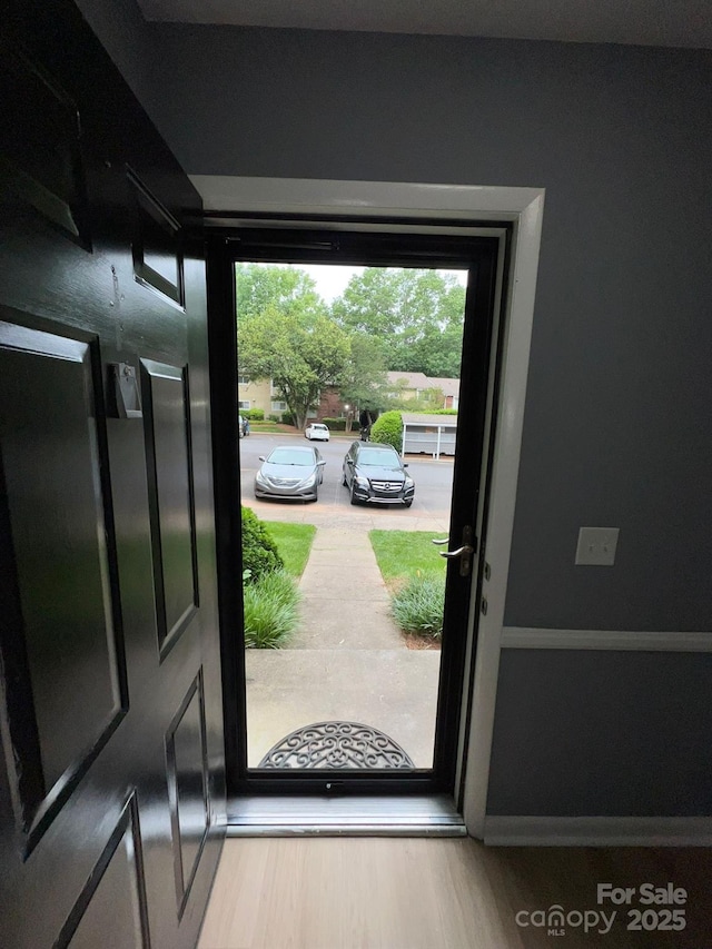 doorway to outside with hardwood / wood-style flooring