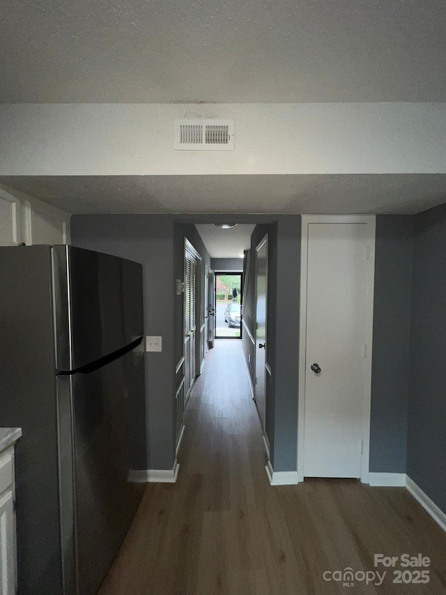 hallway with wood-type flooring