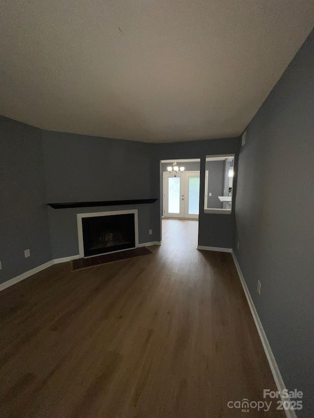 unfurnished living room featuring a fireplace and hardwood / wood-style floors