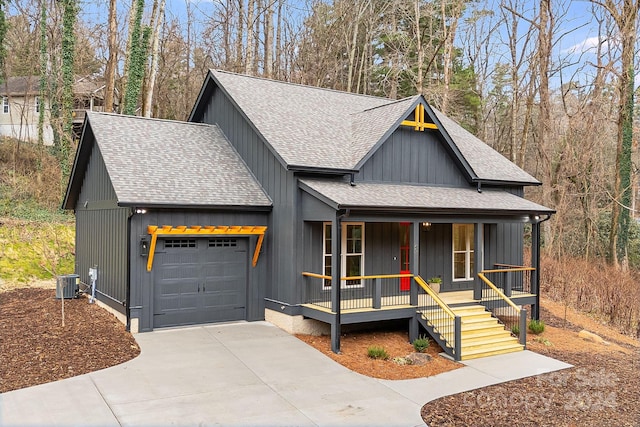 view of front of home with a porch, a garage, and central air condition unit