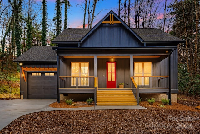 view of front of home with covered porch and a garage