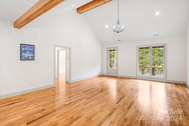 unfurnished living room with beamed ceiling, light hardwood / wood-style floors, a notable chandelier, and high vaulted ceiling