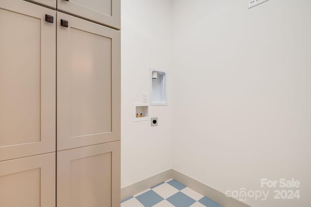 washroom with hookup for an electric dryer, cabinets, and hookup for a washing machine