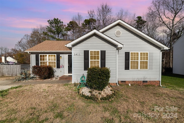 single story home featuring a yard