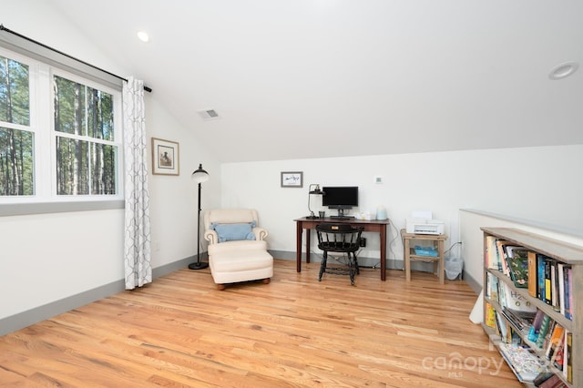 living area featuring lofted ceiling and light wood-type flooring