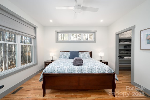 bedroom with light hardwood / wood-style flooring and ceiling fan